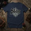Navy t-shirt with "Slay" in gothic font, surrounded by geometric lines and metallic accents