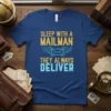 T-shirt with yellow text "SLEEP WITH A MAILMAN" above a winged envelope graphic and blue text "THEY ALWAYS DELIVER"