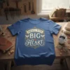 Small Tits Big Heart quote on a blue t-shirt with decorative scrollwork and small heart graphic
