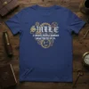 Steampunk t-shirt design with the quote "SMILE IT MAKES PEOPLE WONDER WHAT YOU'RE UP TO." and a winking gear face