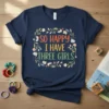 So Happy I Have Three Girls text in colorful font with floral wreath on navy t-shirt