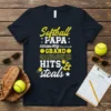 Softball Papa My Granddaughter Hits & Steals t-shirt design with yellow and white text, softball graphics, and baseball bat illustration