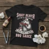 Black t-shirt featuring a beaver eating BBQ ribs with the text "Soggy Beaver If It's Not All Over Your Face