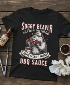 Black t-shirt featuring a beaver eating BBQ ribs with the text "Soggy Beaver If It's Not All Over Your Face