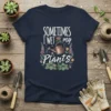 Sometimes I Wet My Plants quote on a navy blue t-shirt with a watering can and floral graphics