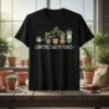 Sometimes I Wet My Plants quote on a black t-shirt with cute cartoon potted plants and a watering can graphic