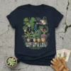 Sometimes I Wet Wet My Plants quote on a navy t-shirt surrounded by various potted houseplants and a watering can
