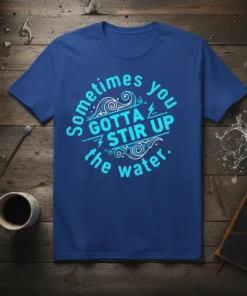 Sometimes You Gotta Stir Up The Water quote t-shirt in blue with stylized waves and lightning graphics