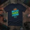 SON. BROTHER. GAMER. LEGEND! text in vibrant colors with a gamepad graphic, on a dark navy t-shirt