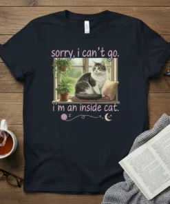 Graphic tee with "sorry, i can't go. i'm an inside cat." text and a cat sitting by a window