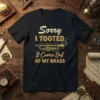 Sorry I TOOTED It Came Out OF MY BRASS text with trumpet graphic on a black t-shirt