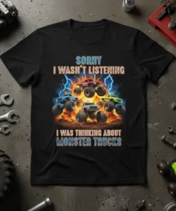 Sorry I Wasn't Listening I Was Thinking About Monster Trucks quote on a black t-shirt with graphic of monster trucks