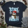 Stay Frosty t-shirt design with a cool snowman wearing sunglasses and a scarf, surrounded by snowflakes