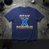 STAY X POSITIVE text graphic with a neon blue X on a navy t-shirt, motivational design