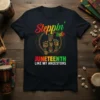 Juneteenth t-shirt with "Steppin' into Juneteenth Like My Ancestors" text and colorful African-inspired graphic