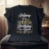 Stepping into my 68th Birthday Like a Queen text with crowns and decorative elements on a black t-shirt design