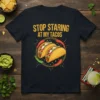 Stop Staring At My Tacos funny quote t-shirt design with illustrated tacos and chili peppers