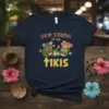 Stop Staring At My Tikis t-shirt design featuring two colorful tiki masks and tropical flowers