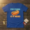 Funny "Stop Staring At My Wiener" t-shirt design with a cartoon hot dog graphic and neon-style text