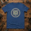 Straight Outta Hours text with piston graphic on a vintage-style circular design on a blue t-shirt