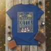 Straight Outta Minnesota text design with a vintage border, featuring a flying bird and flowers, on a blue t-shirt