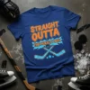 Blue t-shirt with orange and light blue text "STRAIGHT OUTTA THE PENALTY BOX" and hockey stick graphics
