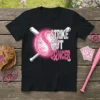 Black t-shirt with "STRIKE OUT CANCER" text and a pink baseball with bats, promoting breast cancer awareness