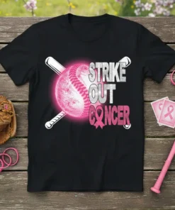 Black t-shirt with "STRIKE OUT CANCER" text and a pink baseball with bats, promoting breast cancer awareness