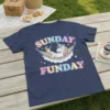 Sunday Funday text with a relaxed unicorn in a hammock on a navy blue t-shirt