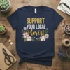 Support Your Local Florist t-shirt with floral design, featuring yellow and white text and pink and white flowers