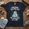 Surviving The Sped Life One Meltdown At A Time quote with a melting snowman graphic on a navy t-shirt