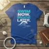 Swim Now Breathe Later T-Shirt with a large ocean wave graphic and text in blue and white