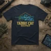 Tabby Cat Sniper T-Shirt design featuring a tabby cat with a sniper rifle, set against a hexagonal background with circuit