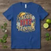 Blue t-shirt with "Tacos Tits Tequila" text design featuring a taco and a cocktail illustration