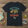 Funny "TAKE IT EASN ME EASY ON ME MY WIFE IS PREGNANT" quote on a navy t-shirt with baby footprint