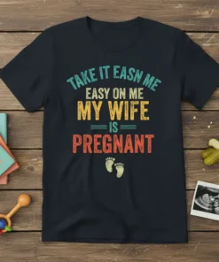 Funny "TAKE IT EASN ME EASY ON ME MY WIFE IS PREGNANT" quote on a navy t-shirt with baby footprint
