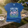 Take Me To My Aunt You Peasant funny quote on a blue t-shirt with bees, birds, mushrooms, and floral accents
