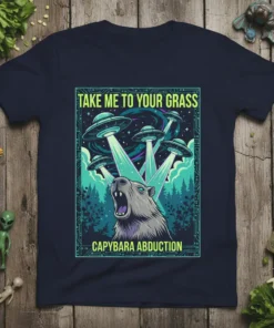 T-shirt design featuring a capybara being abducted by multiple UFOs with the text "Take Me To Your Grass" and "Capybara