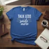 Talk Less Smile More quote t-shirt with a smiley face graphic in white and yellow typography