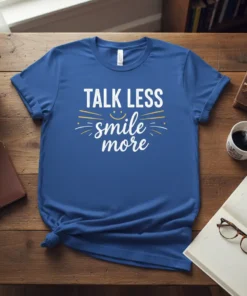 Talk Less Smile More quote t-shirt with a smiley face graphic in white and yellow typography