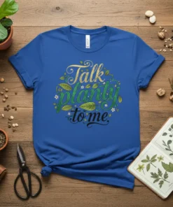 Blue t-shirt with "Talk planty to me" text in green and gold, surrounded by leaves and flowers