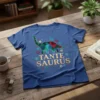 Tante Saurus Dinosaur T-Shirt with a geometric dinosaur graphic and glitter text, surrounded by floral accents