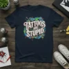 Tattoos Are Stupid text design with tattoo gun graphics on a navy t-shirt