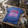 Taylor Taylor Taylor Taylor Taylor repeated name graphic on a blue t-shirt with crown and paint splatters