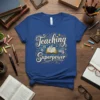 Teaching is my Superpower quote with open book graphic on a royal blue t-shirt
