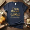 Team Biscuit It's cind my thing... quote on a navy t-shirt with gold glitter text and a mustache graphic