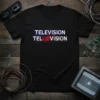 Black t-shirt with white and red text reading "TELEVISION" above "TELLIEVISION" with glitchy circuit board graphics, Television Tellievison design