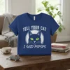 Tell Your Cat I Said Pspsps funny quote t-shirt with a graphic of a black cat's face and green eyes