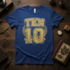Blue t-shirt with gold and white "TEN 10" graphic, featuring laurel wreaths and geometric patterns