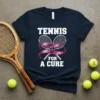 Tennis rackets crossed with a pink ribbon on a navy t-shirt, text "TENNIS FOR A CURE" above and below